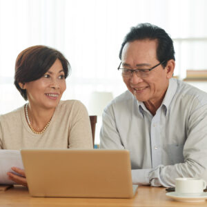 Aged Husband and Wife Using Laptop